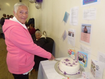 Isobel Swain cutting her 90th birthday cake.