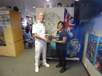 Captain Hamish Elliott presenting the Head of Tourism with ship's plaque for her maiden voyage.