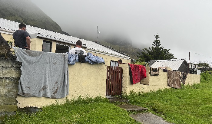 Flood damaged carpets, mats and fabrics hung out to dry outside one of the affected island homes.