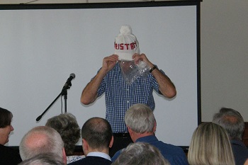 Richard Grundy models a hat during the auction.