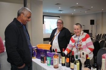 Frank Rogers eyes up the raffle prizes with Tracy Tough and Gwynneth Cooper