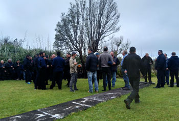 Men drinking and chatting in the Residency garden at the Admin's reception