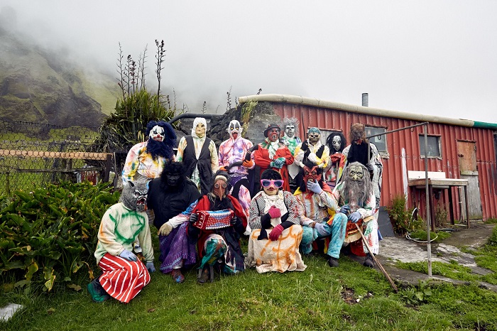 Okalolies pose outside a shack