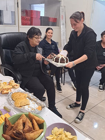 Marion cutting the cake