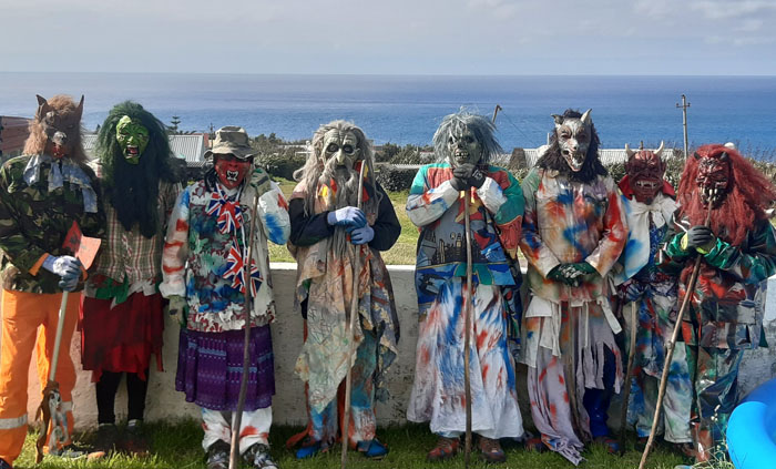 The Okalolies pose for a photo in a garden during their circuit of the community.