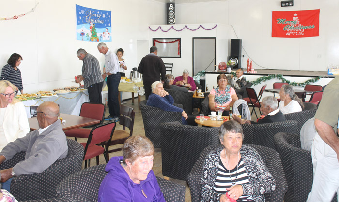 Socialising and buffet at the pensioners' Christmas party.