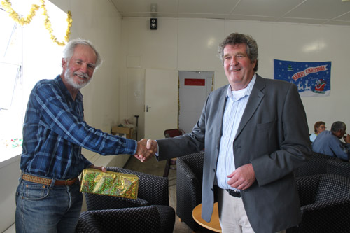 Sean Burns presenting a gift to Dr Joe Tyrell
