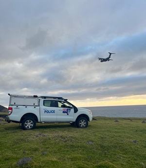 Police vehicle with A400M flying overhead