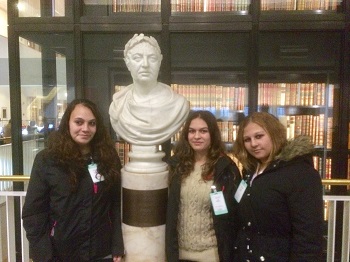 Rhyanna, Jade and Janice pose next to the bust of George III in front of the King's Library tower.
