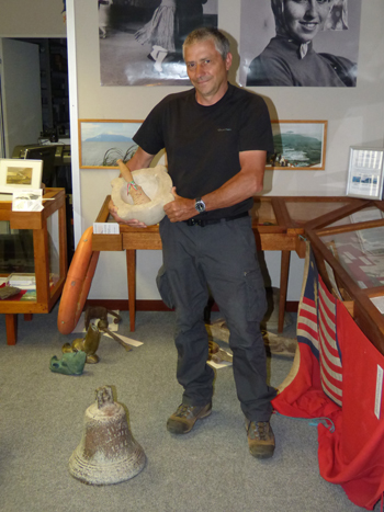Gianfranco inspects relics from the wreck of the ship Italia, which brought his ancestor to Tristan.