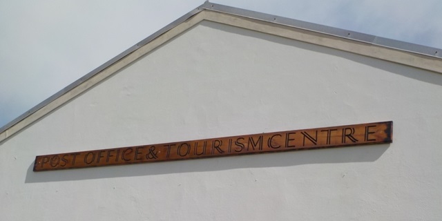 The new Post Office and Tourism Center sign in place