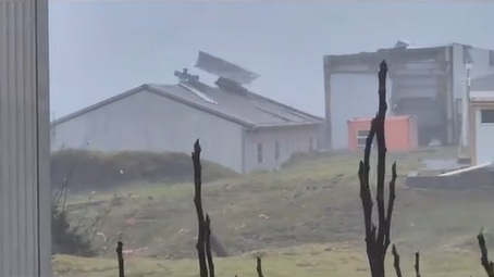This still from a video shot by Fouche Conradie show roofing sheets being ripped off by the storm.