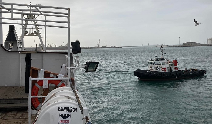 Pilot boat Kestrel pulls the MFV Edinburgh away from the quay in Cape Town harbour.