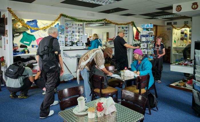Visitors writing postcards in the gift shop (Photo: Julia Gunther)