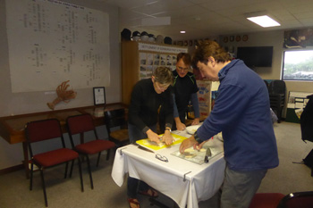 Visitors making traditional Tristan snislens.