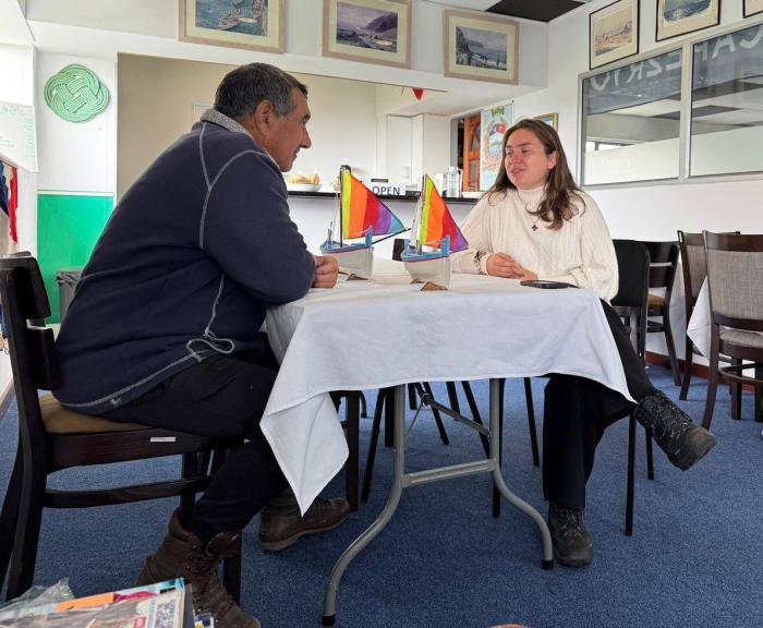 Odile Cesari talks with Brian Rogers about his model longboats. Photo: Kelly Green