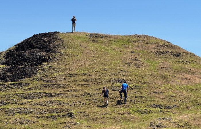 The Vineta's crew climbing a hill during their Patches hike for a good view of the landscape.