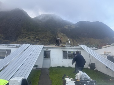 Repairing the roof of an island family's home. Photo: Kelly Green