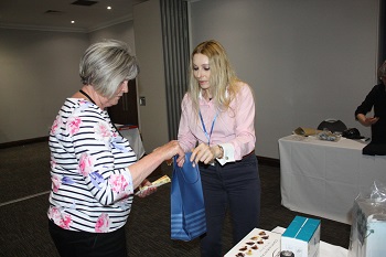 Jenny Craig and Isolde Mueller pick up their raffle prizes