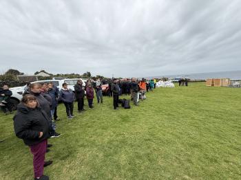 People watching helicopter departures. There is a pile of mailbags in the background. Photos: Philip Kendall