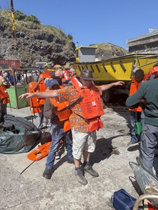 Not being frisked! Visitor Chris Farrell being helped with his life vest. (Photo: Philip Kendall)