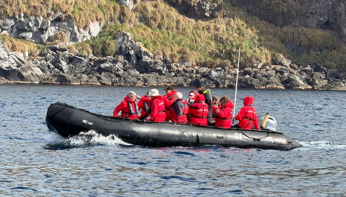 Zodiac cruise along the coast of Inaccessible Island. Photo: Trevor Glass