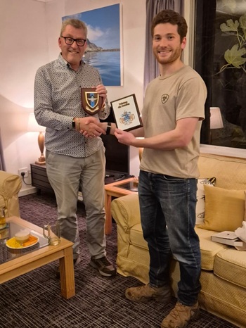 Administrator Philip Kendall exchanging plaques with Captain George Lacey