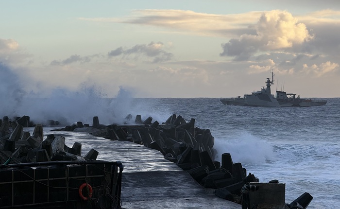 Stormy weather at Calshot Harbour with HMS Medway stationed offshore.