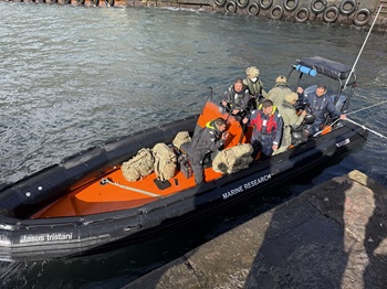 Paratroopers and their backpacks leaving in the Fisheries RIB