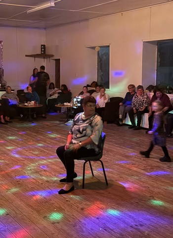 Cynthia waiting to be offered a partner in the Chair Dance. Will she or won't she accept?