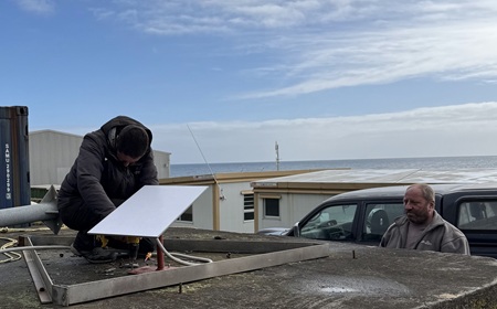 Chief Islander Ian Lavarello watches the Starlink antenna being secured.