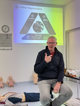 Prof. Ian Cumming conducting First Response Emergency Care training.