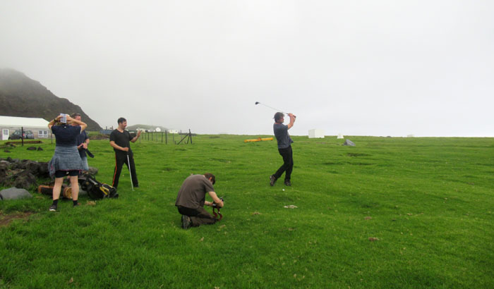 Passengers and voyage crew playing golf on the island's course