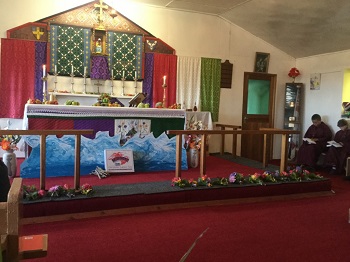 Harvest Festival produce and Mothering Sunday posies at St Mary's altar.