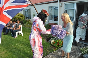 Marina Burns, the Administrator's wife is presented with flowers.