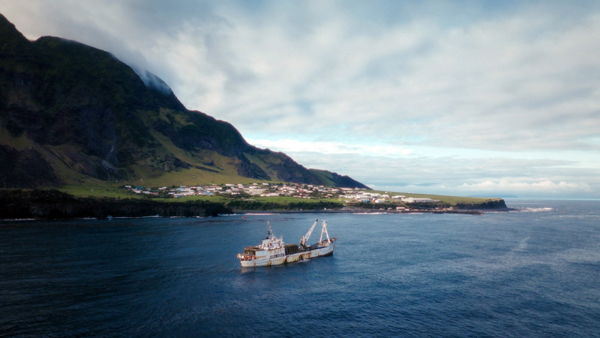 Drone fottage from the film showing MFV Edinburgh with the Tristan Settlement behind