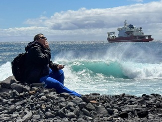 Paula Swain contemplating the ship offshore.