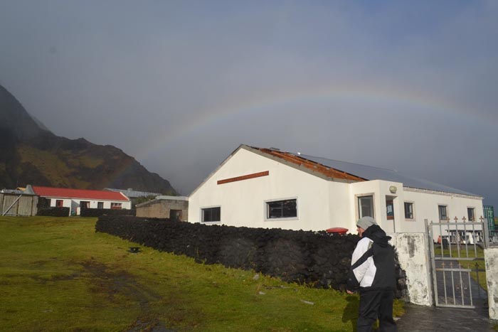 Rainbow over the Post Office and Tourism Centre as another storm approaches, showing the partly missing roof