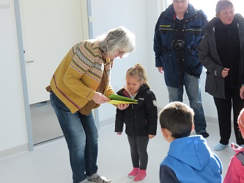 Kate Aimson gives cards to the children