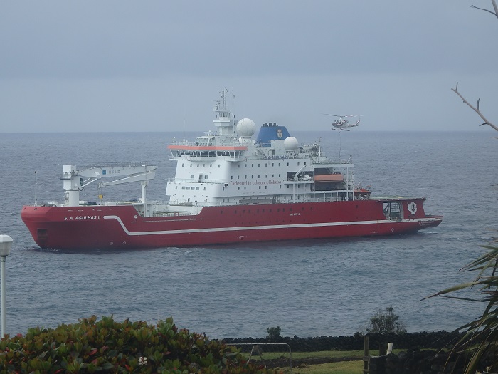 The SA Agulhas II off Tristan as the helicopter delivers the islanders' donations.