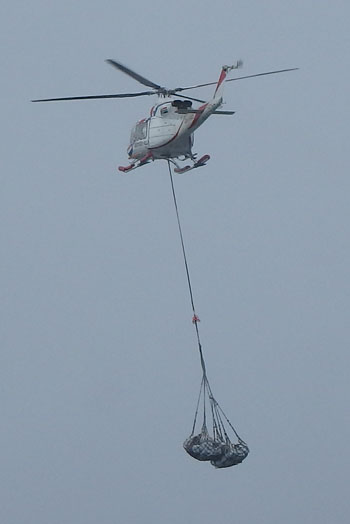 The helicopter carrying the Tristan community's donations for Geo Searcher crew to the Agulhas II
