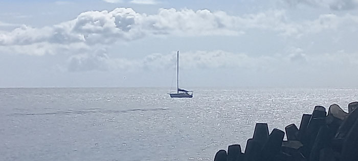 The SV Ray of Light at anchor off Calshot harbour.