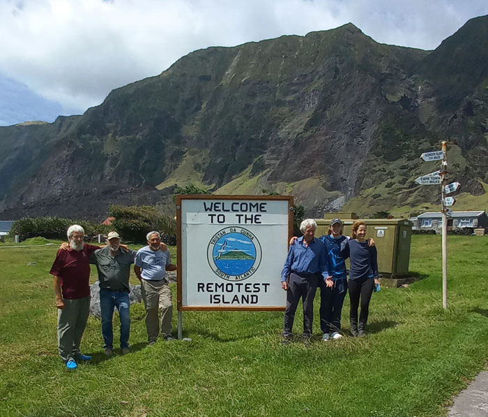 The crew at the Remotest Island sign.