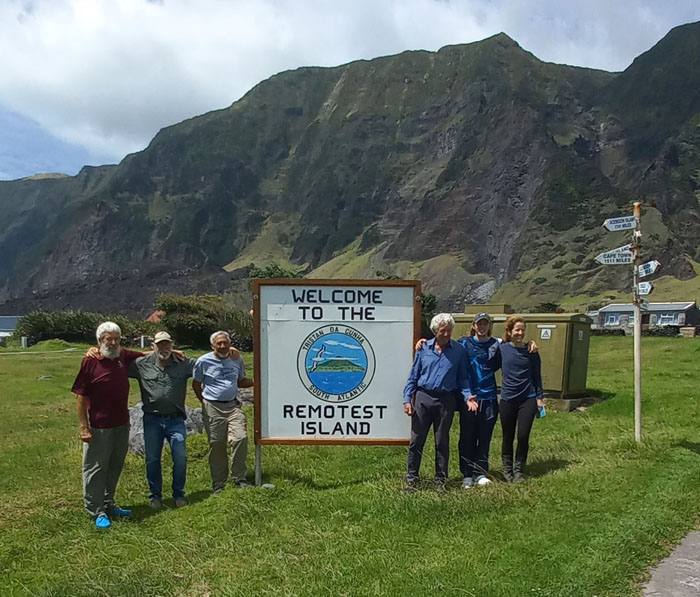 The crew at the Remotest Island sign.