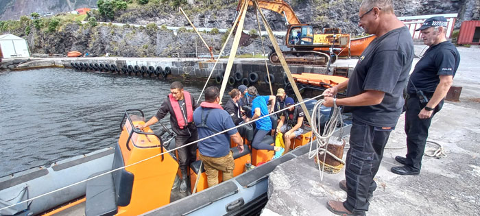 Crew of the SV Nemesis about to return to their yacht on the island's resscue RIB,