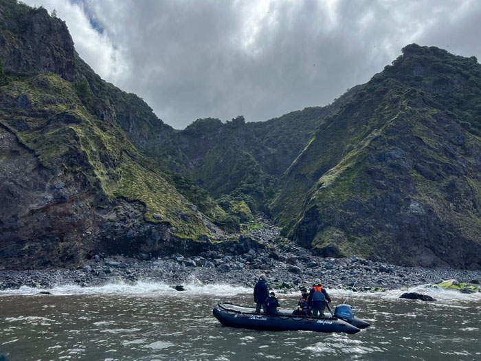 Passengers on a Zodiac tour off Big Gulch where the boulders were covered in Rockhopper penguins.