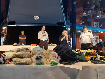 The expedition team introduce Conrad Glass (right), among the stalls piled high with souvenirs.
