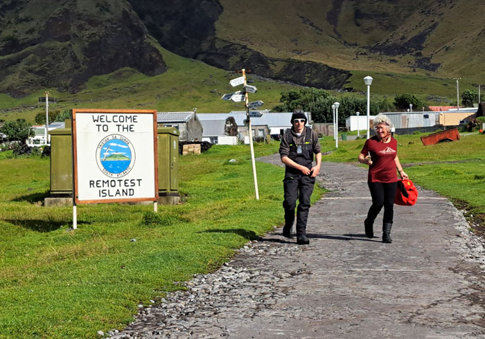 Tecla visitors pass the signs