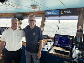 Administrator Philip Kendall with Captain Peik Aalto on the bridge of the National Geographic Explorer